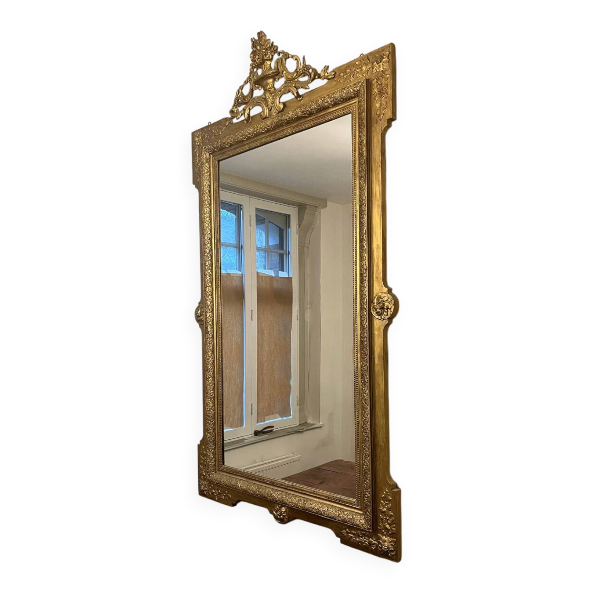 Antique Louis XVI style mirror in gilded wood