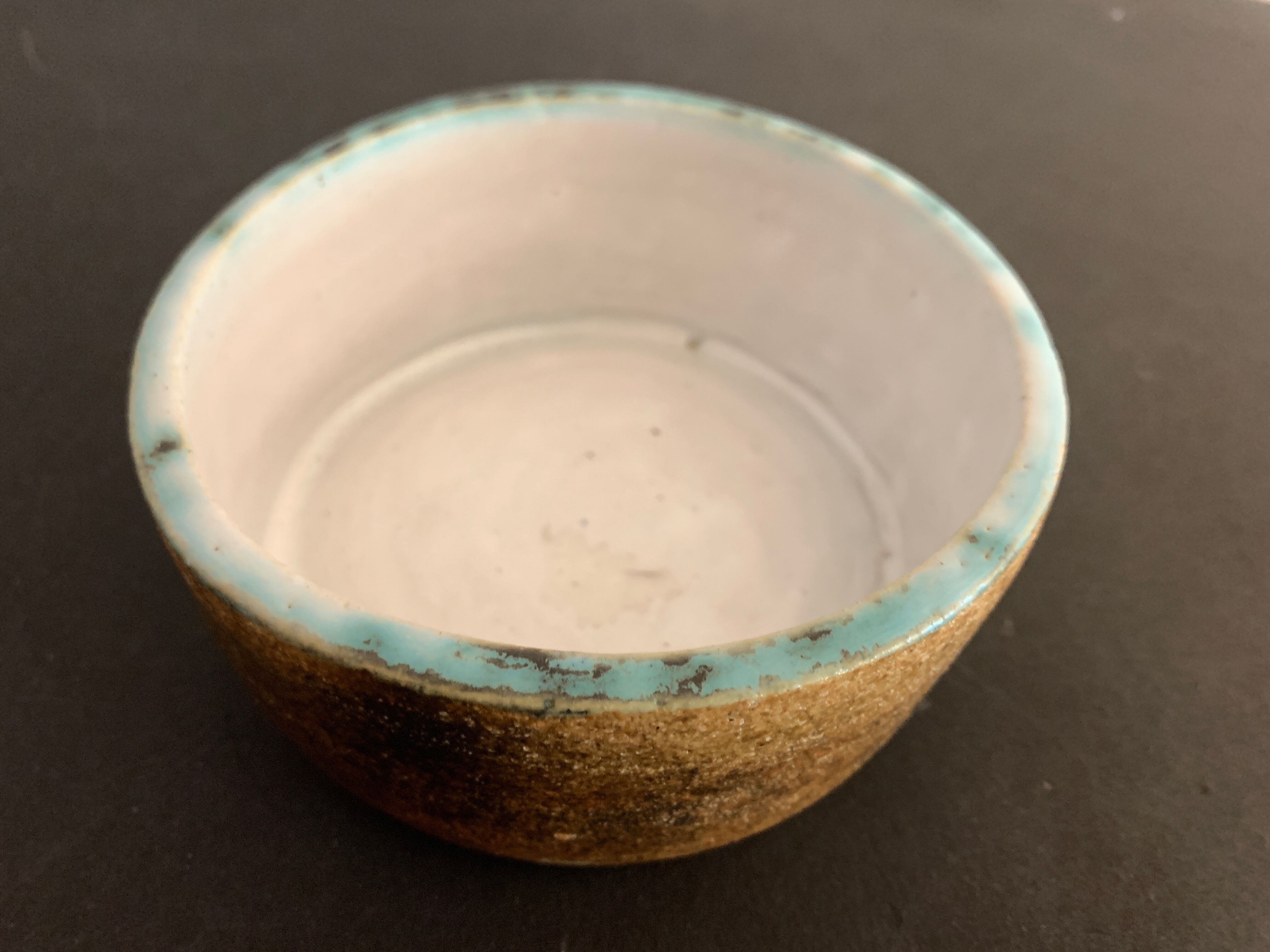 Round ashtray signed in sandstone with glazed interior