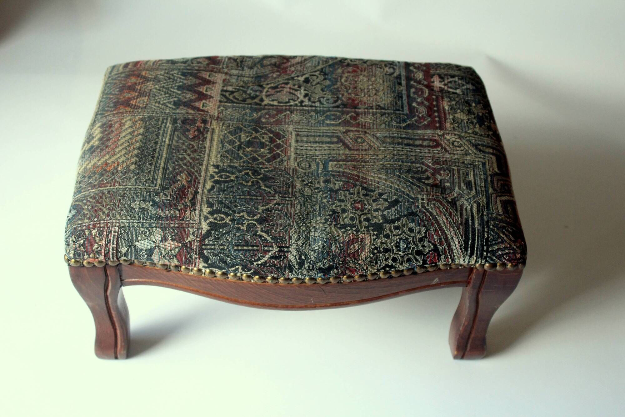 Small foot stool made of wood with upholstery, vintage from the 70s