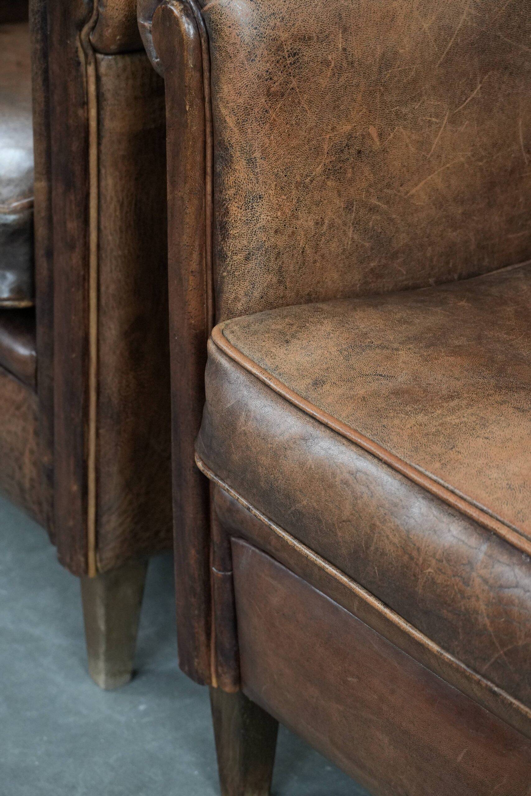 Set of 2 vintage sheepskin armchairs with a characterful appearance
