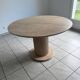 Round table with a travertine effect.