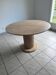 Round table with a travertine effect.