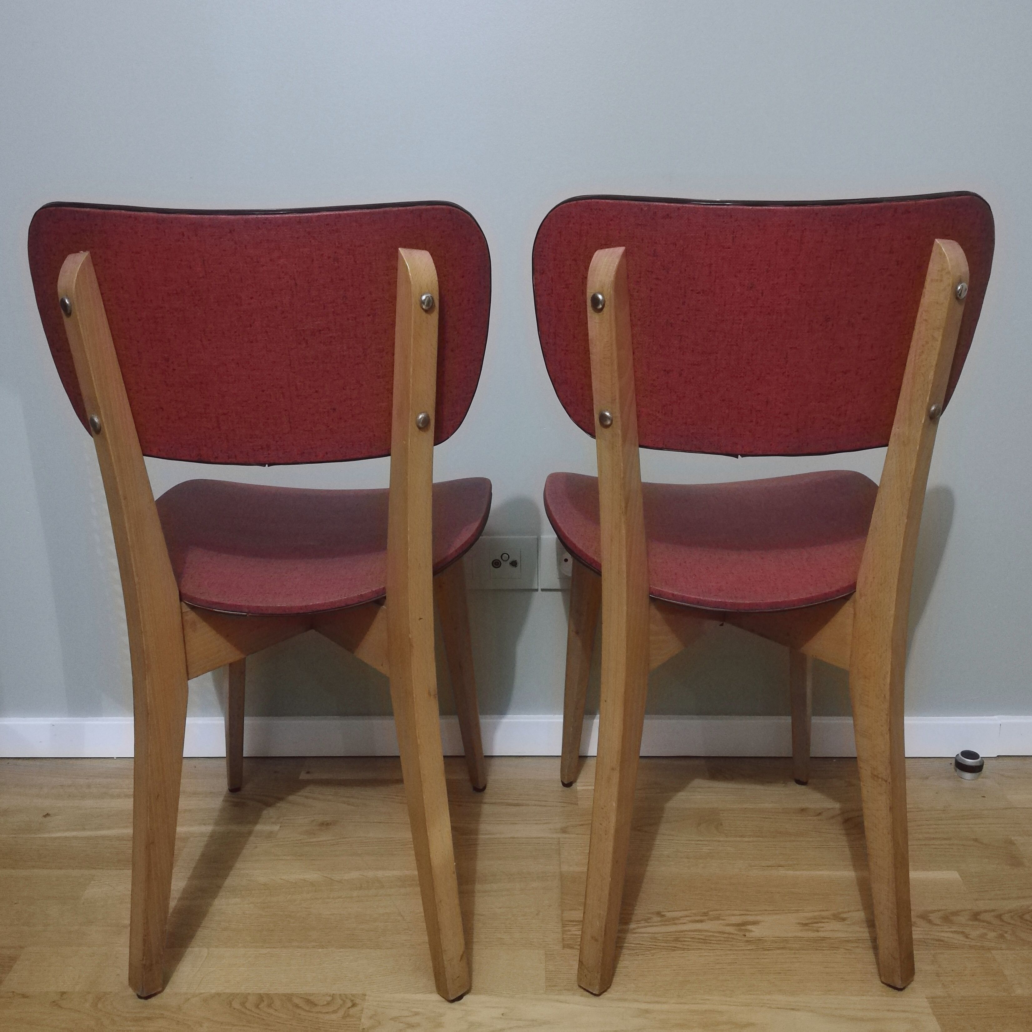 Two vintage chairs wood and mottled red vinyl