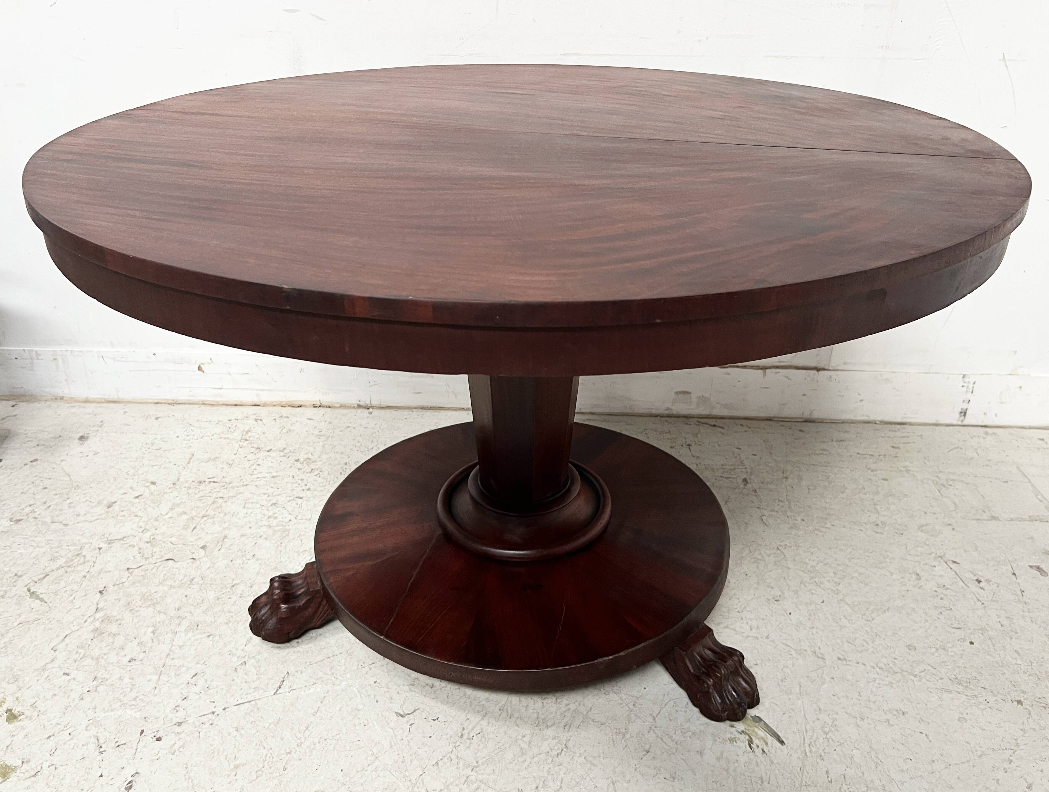 Empire style round table with claw feet, 19th century.