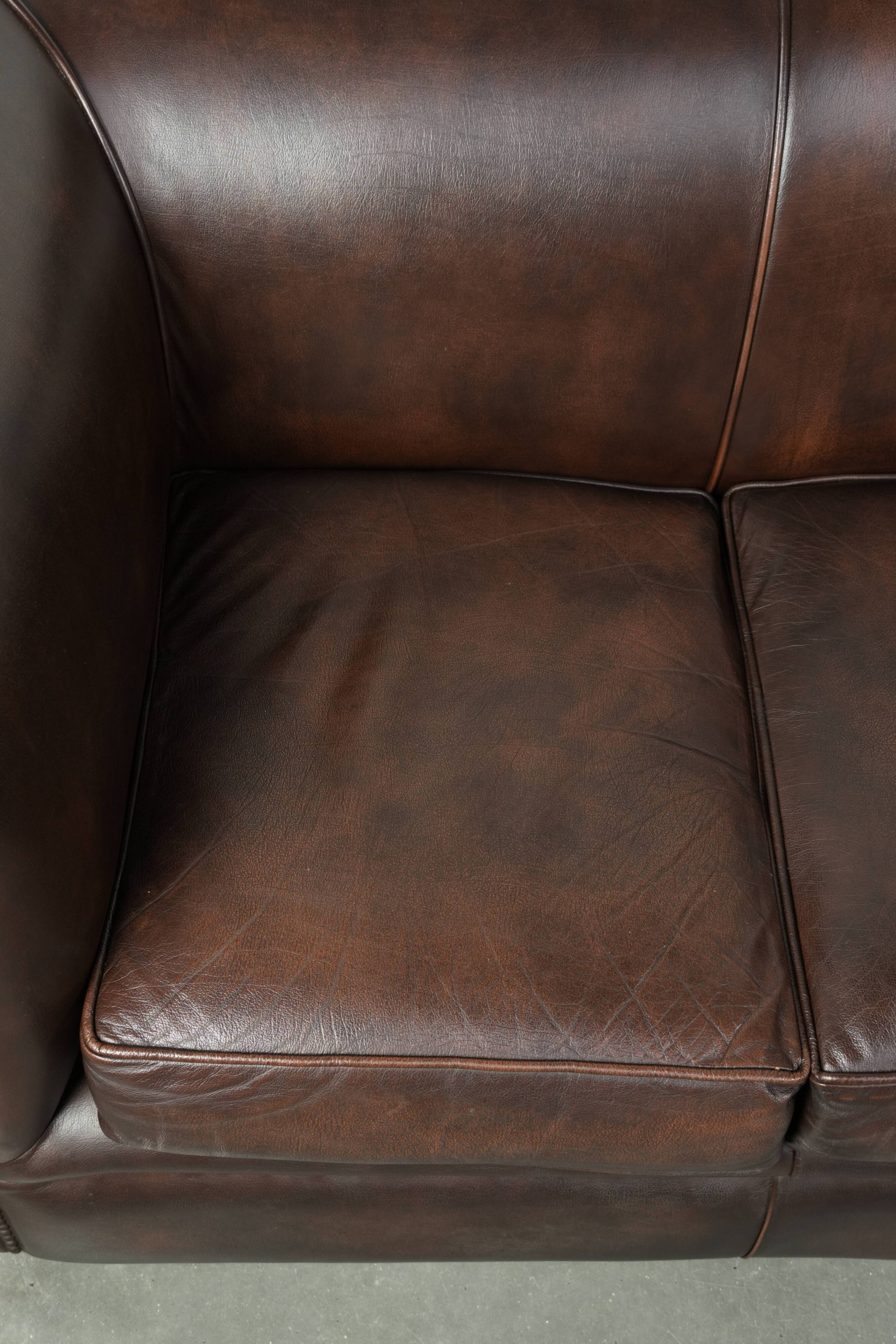 Set of a smooth chesterfield sofa and armchair with a timeless English look