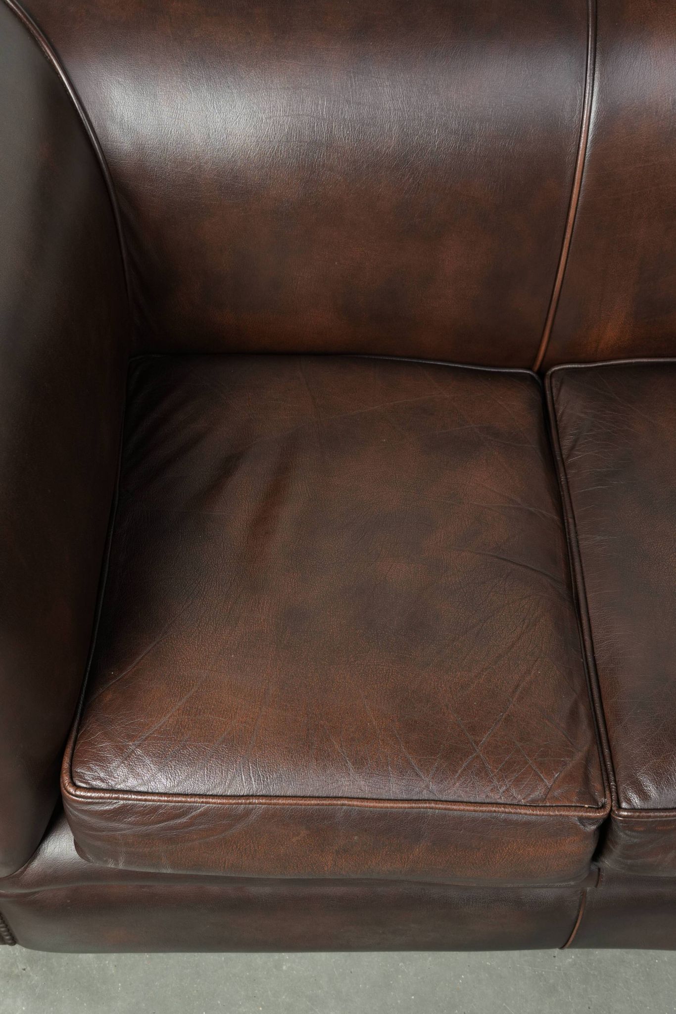 Set of a smooth chesterfield sofa and armchair with a timeless English look