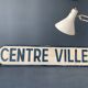 Panneau de signalisation vintage, en bois peint, centre ville.