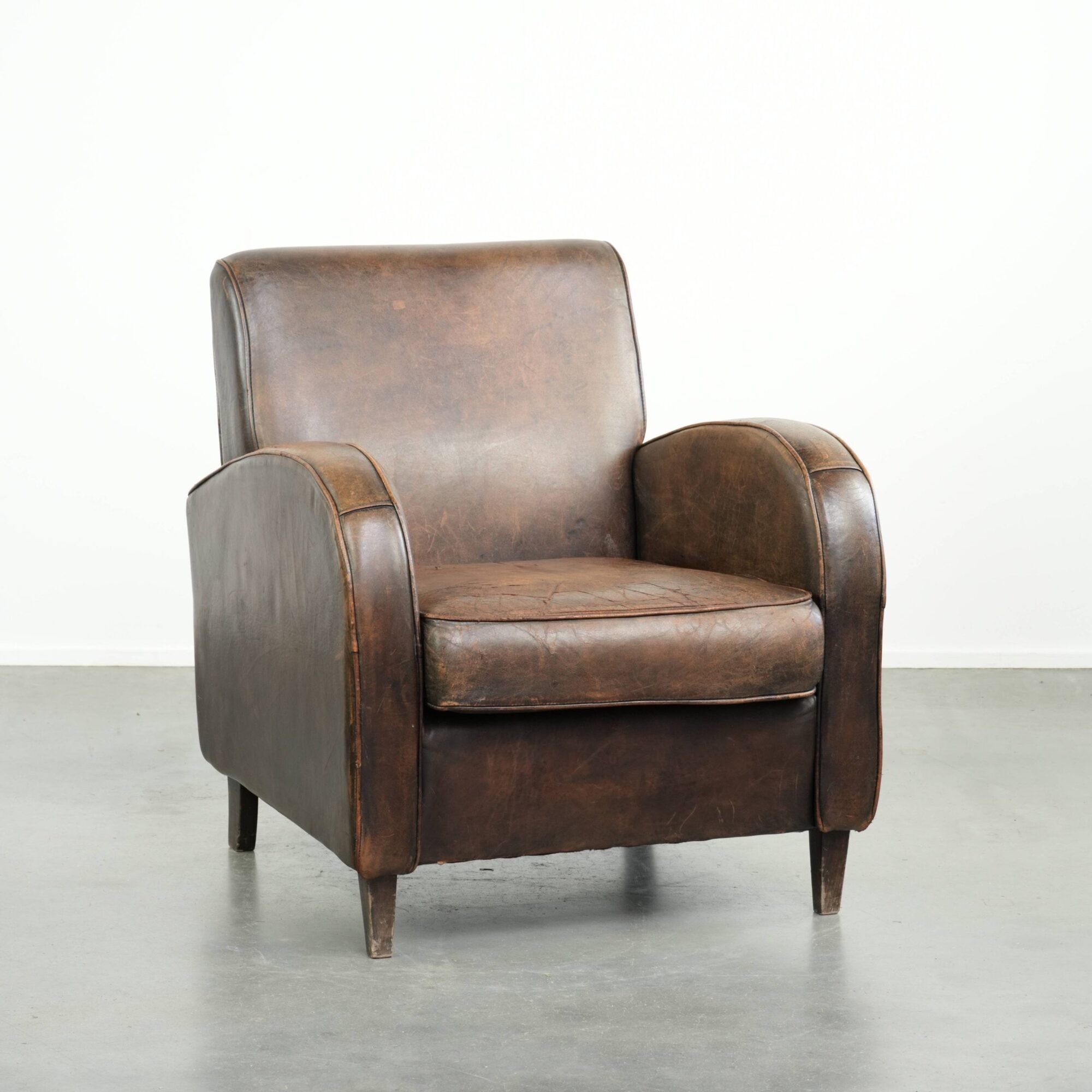 Comfortable sheepskin armchair with matching piping and a timeless look