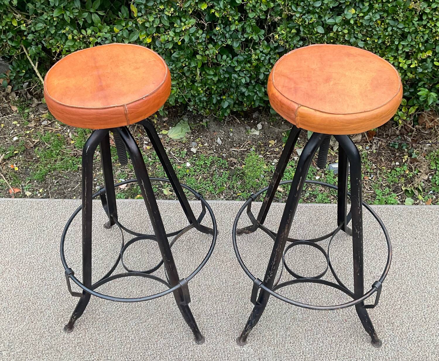 Pair of vintage metal and leather bar stools