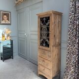 Column storage unit with a sculpted metal door.