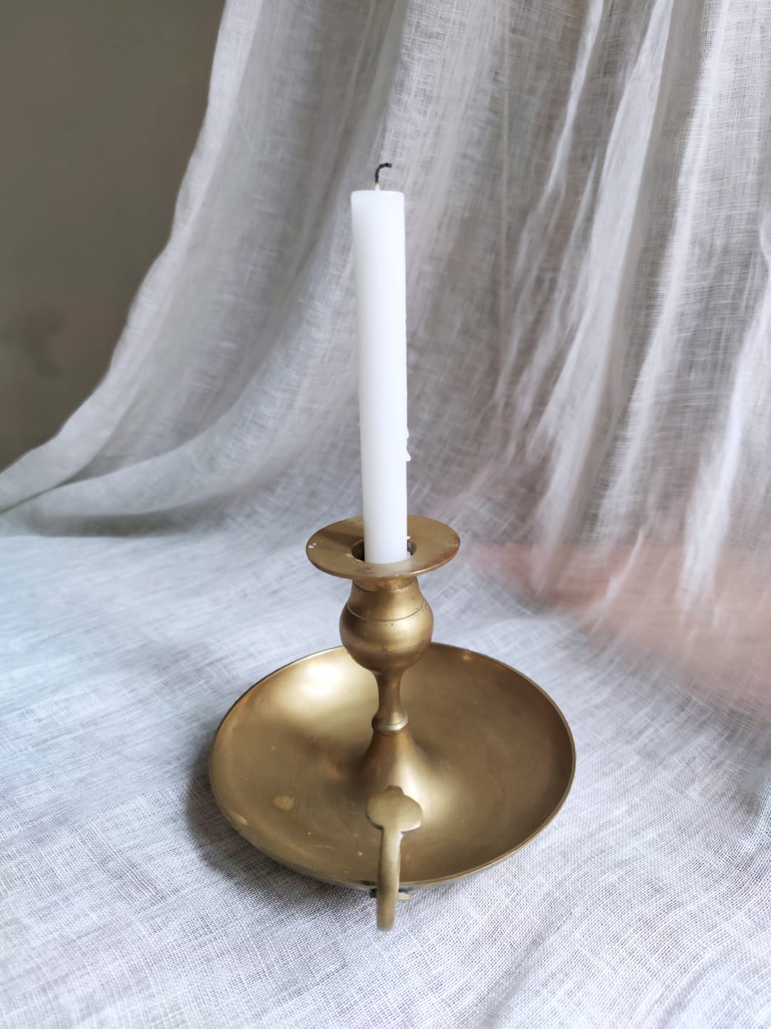Large hand candlestick in gilded brass