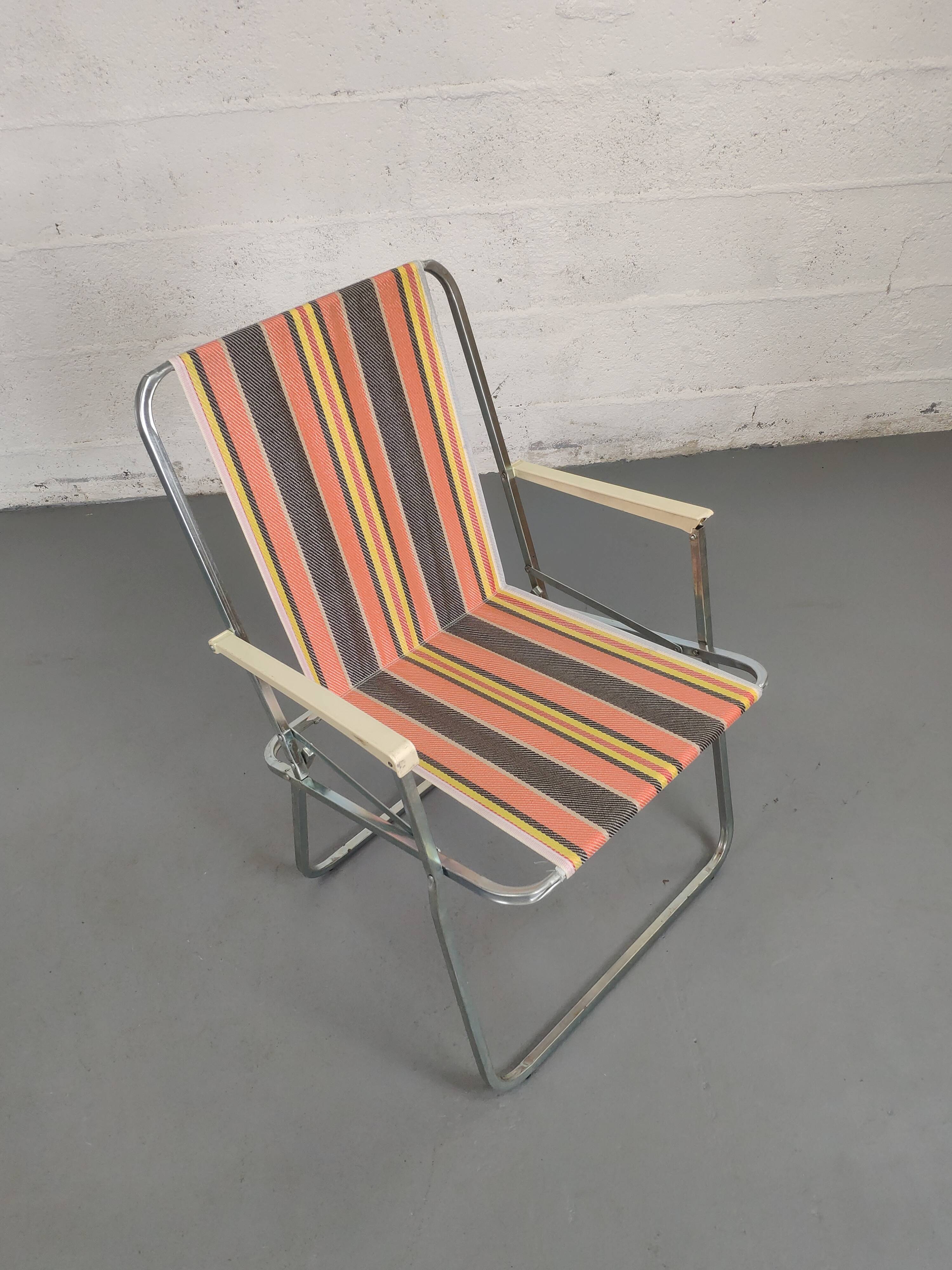 Old folding armchair seaside vintage orange black yellow