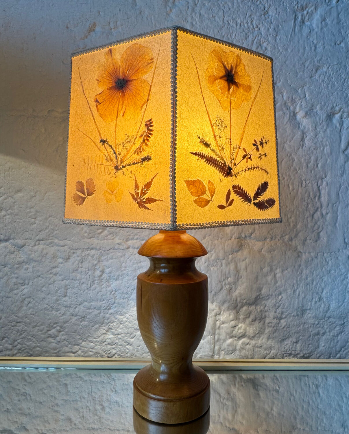 Turned wood lamp with a herbarium lampshade from the 1970s.