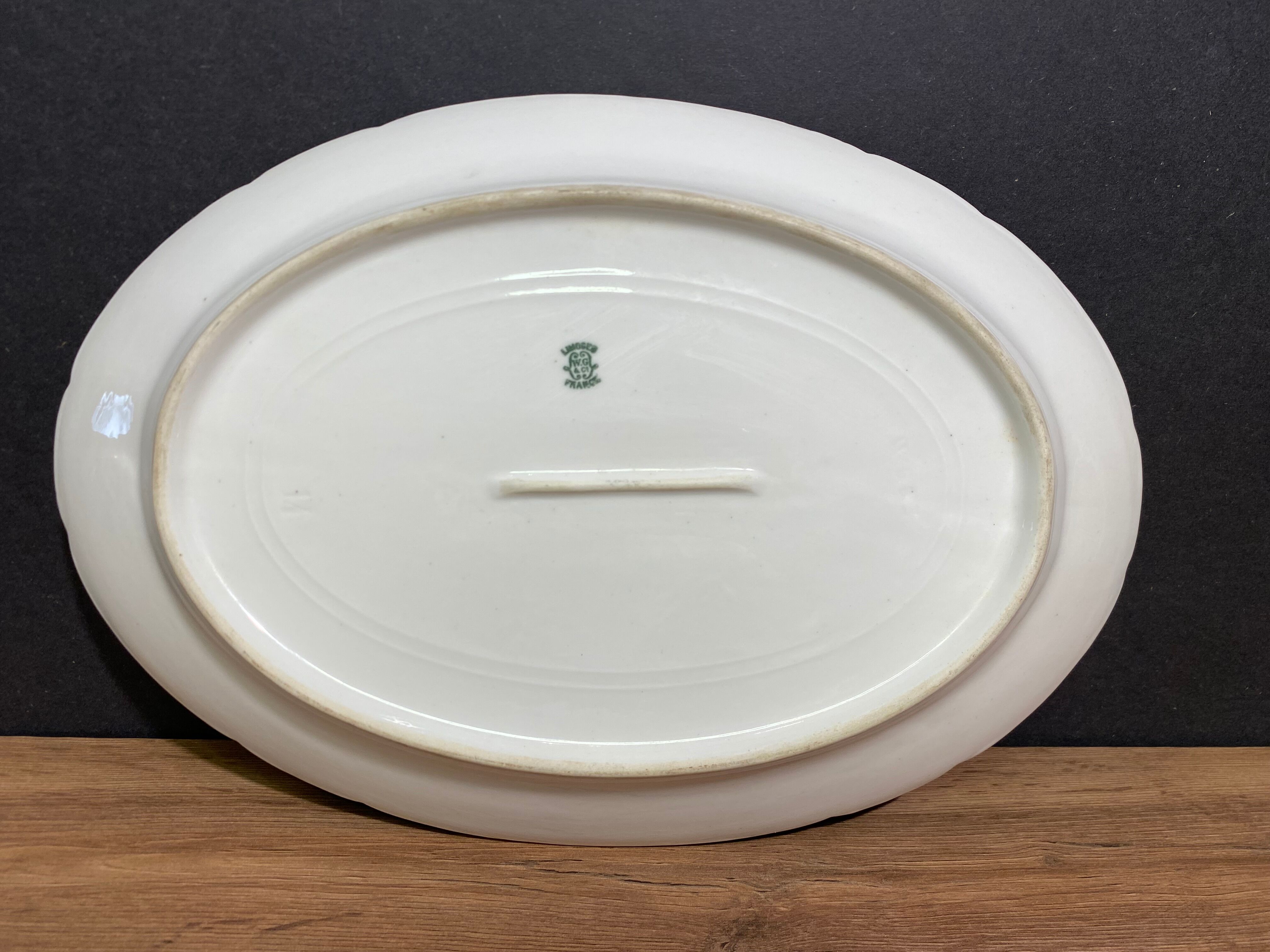 Oval-shaped dish in Limoges porcelain decorated with barbels Louis XV style