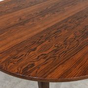 Extendable round rosewood dining table