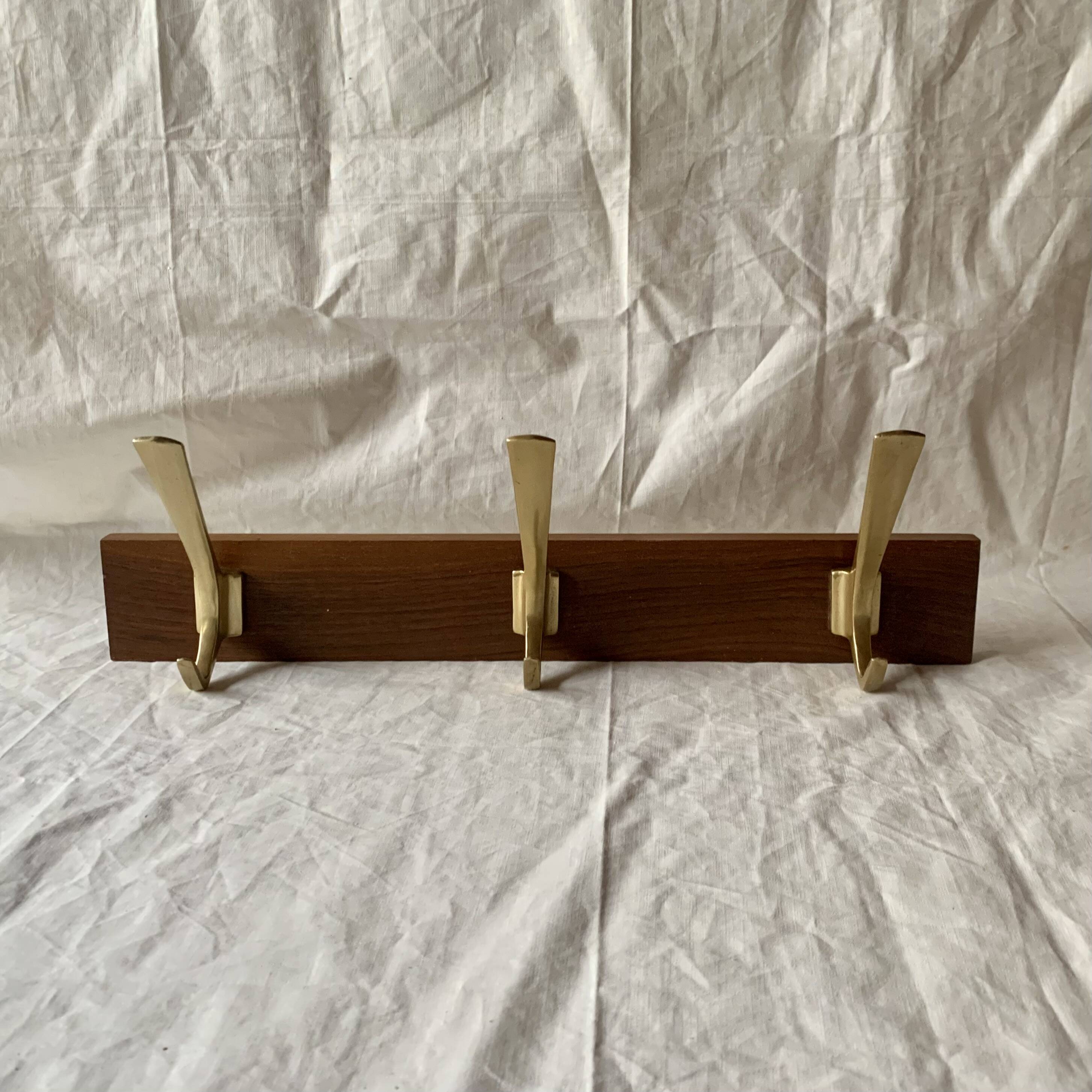 Vintage wooden wall-mounted coat rack with 3 golden cast aluminum hooks