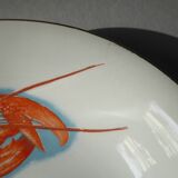 Eight hollow plates decorated with lobsters