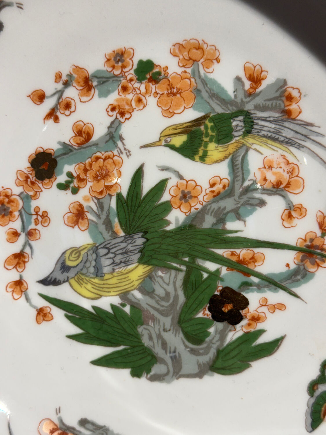 Shallow porcelain plate from Limoges Raynaud, bird decoration.