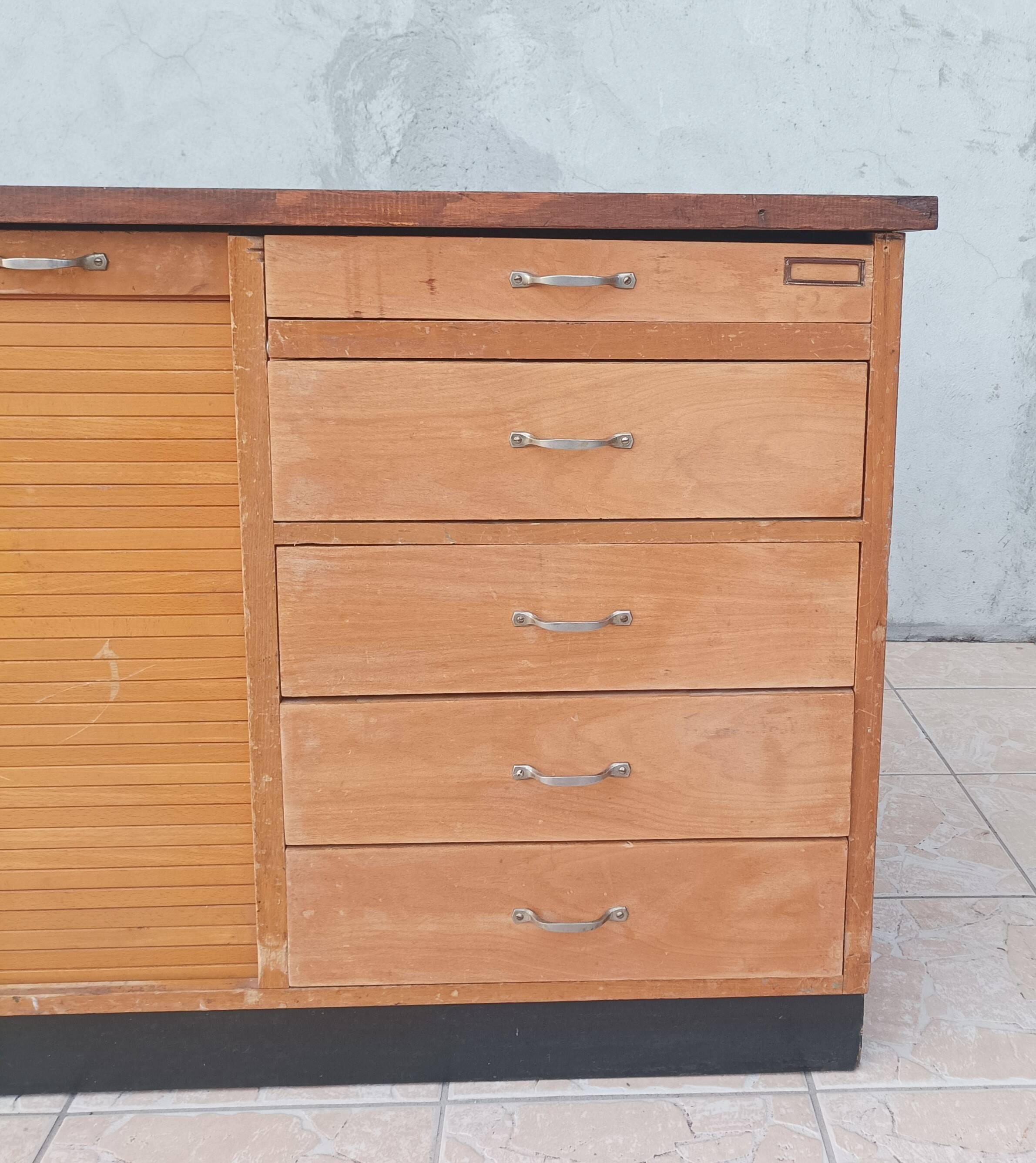 Workshop furniture with drawers and curtain in beech and walnut.