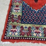 Vintage hand-knotted wool rug with polychrome decoration on a red, blue, green background 150 x 63 cm
