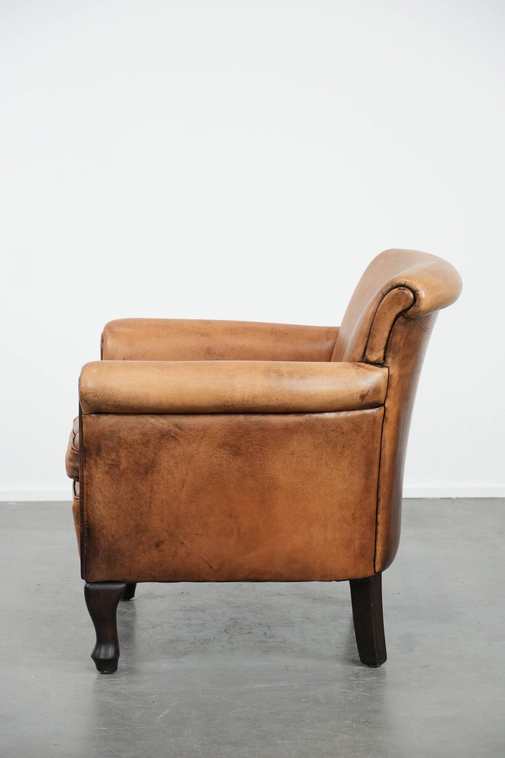 Vintage sheepskin armchair with a beautiful light colour and elegant legs