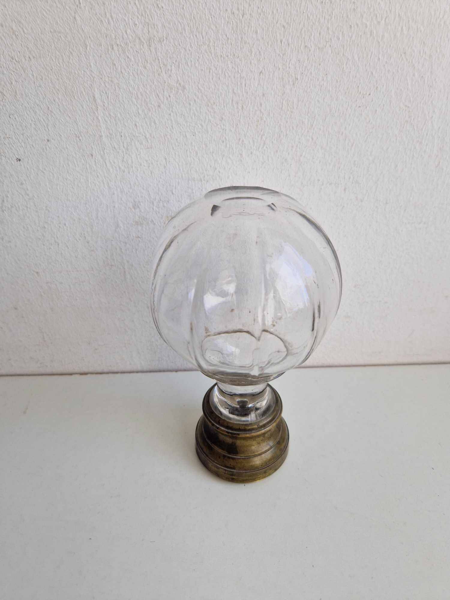 Glass and brass stair ball