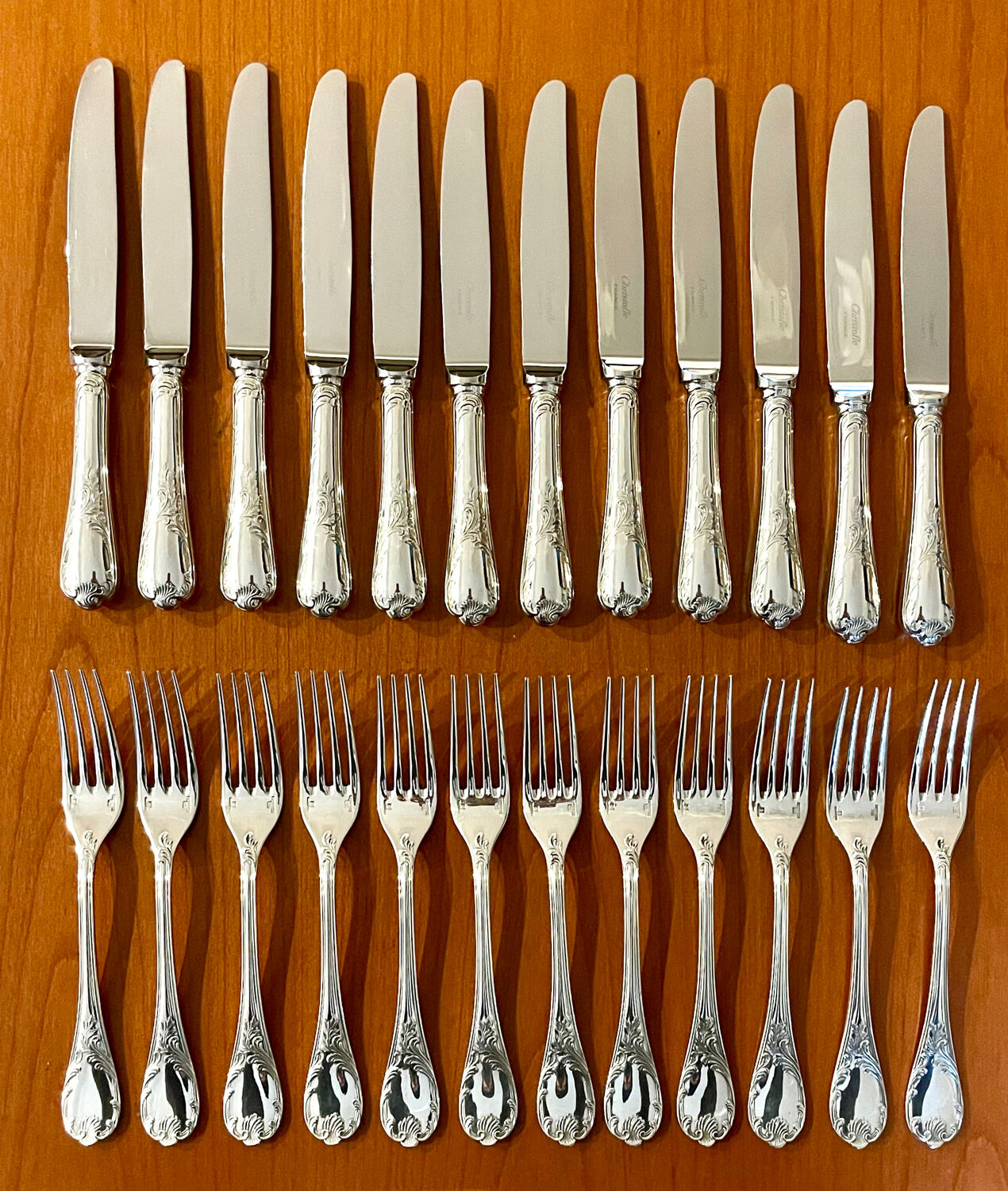 Christofle France, 12 dessert knives and 12 dessert forks in new condition.