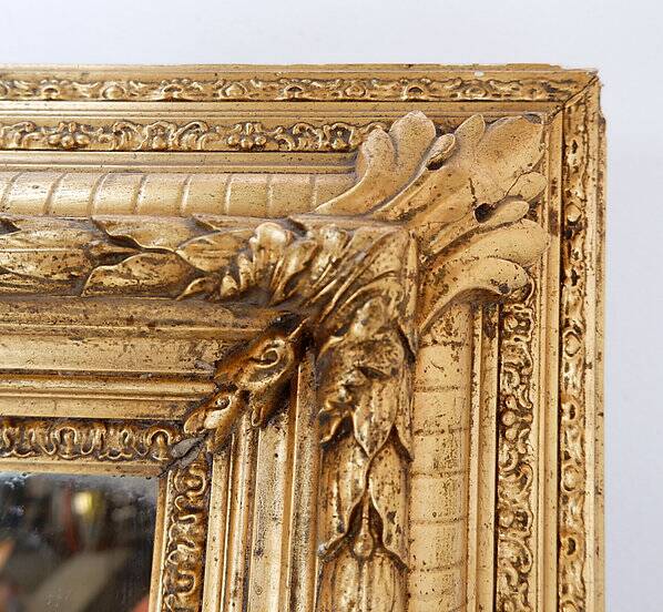Large gilded wood and stucco mirror with foliage