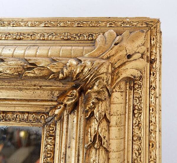 Large gilded wood and stucco mirror with foliage