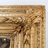 Large gilded wood and stucco mirror with foliage