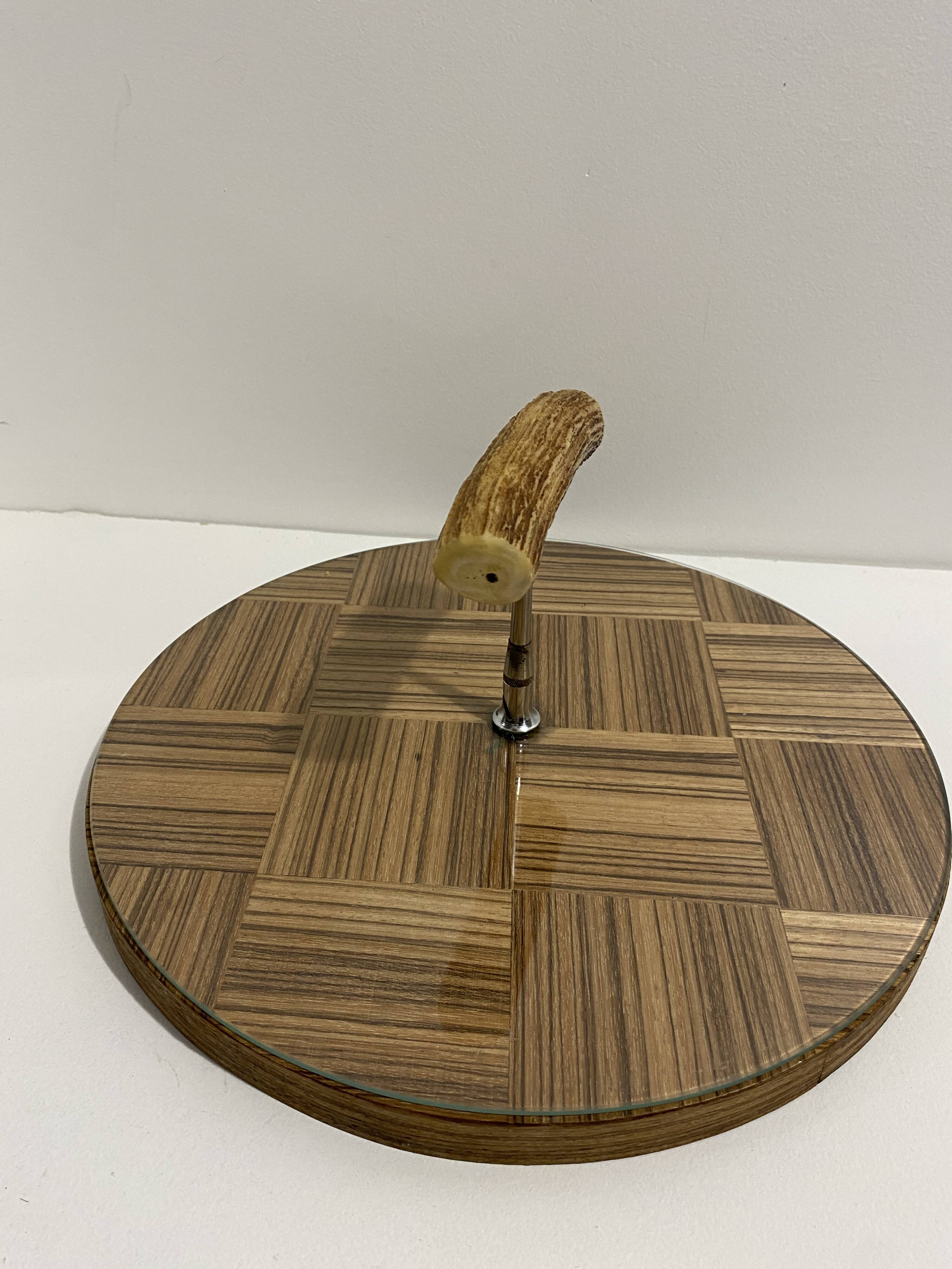 Vintage round wooden cheese board covered with glass plate with foldable handle