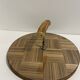 Vintage round wooden cheese board covered with glass plate with foldable handle