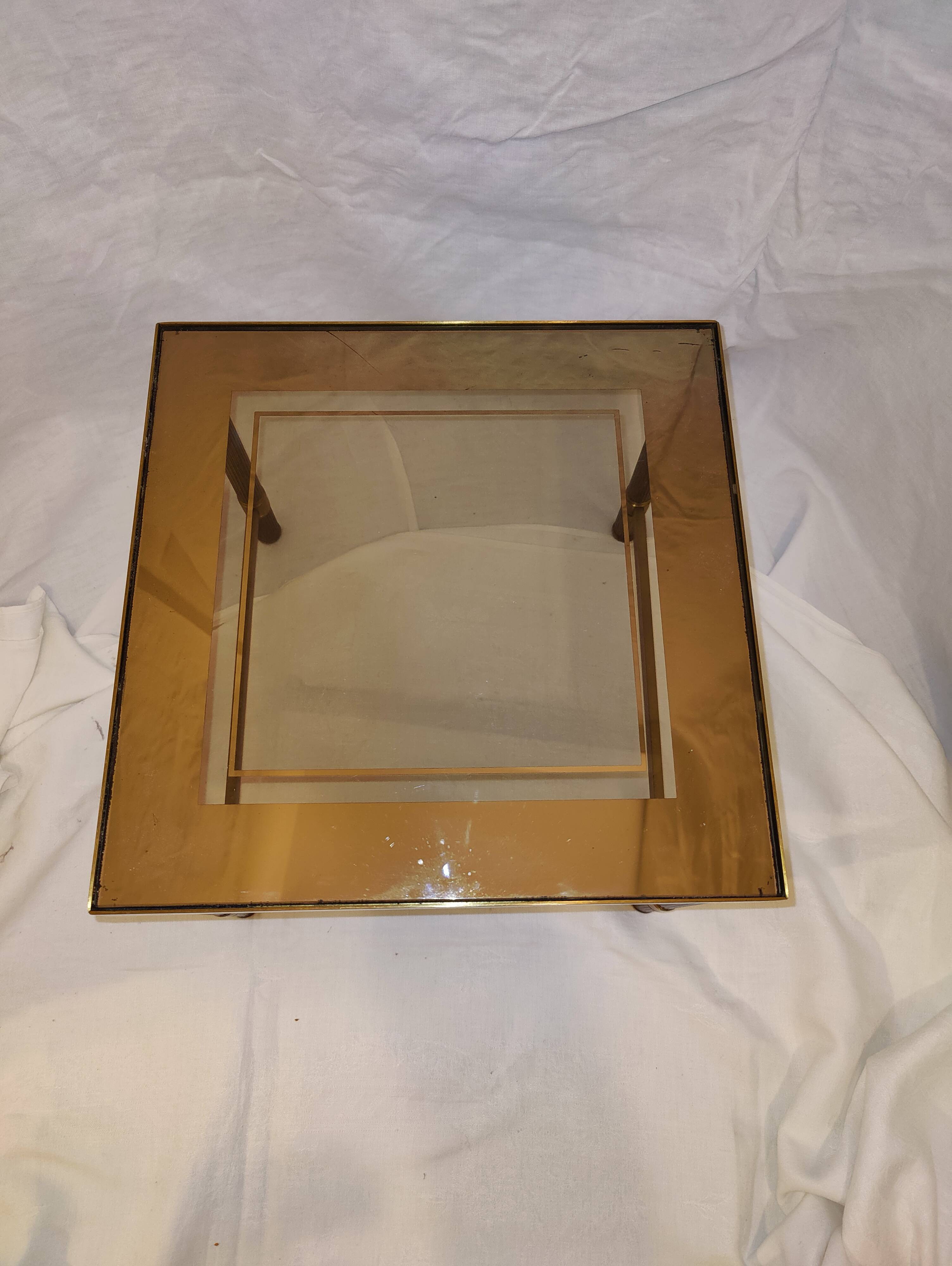 Small table or side table with brass structure and glass top from the 1970s.