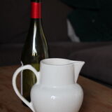 Old pitcher in white earthenware