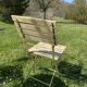 Table et 2 chaises de jardin en métal et bois beige marquées "Bistrot Paris"