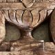 Wall-mounted coat rack on a carved wooden pediment
