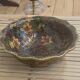 Vintage Asian brass bowl with floral decoration.