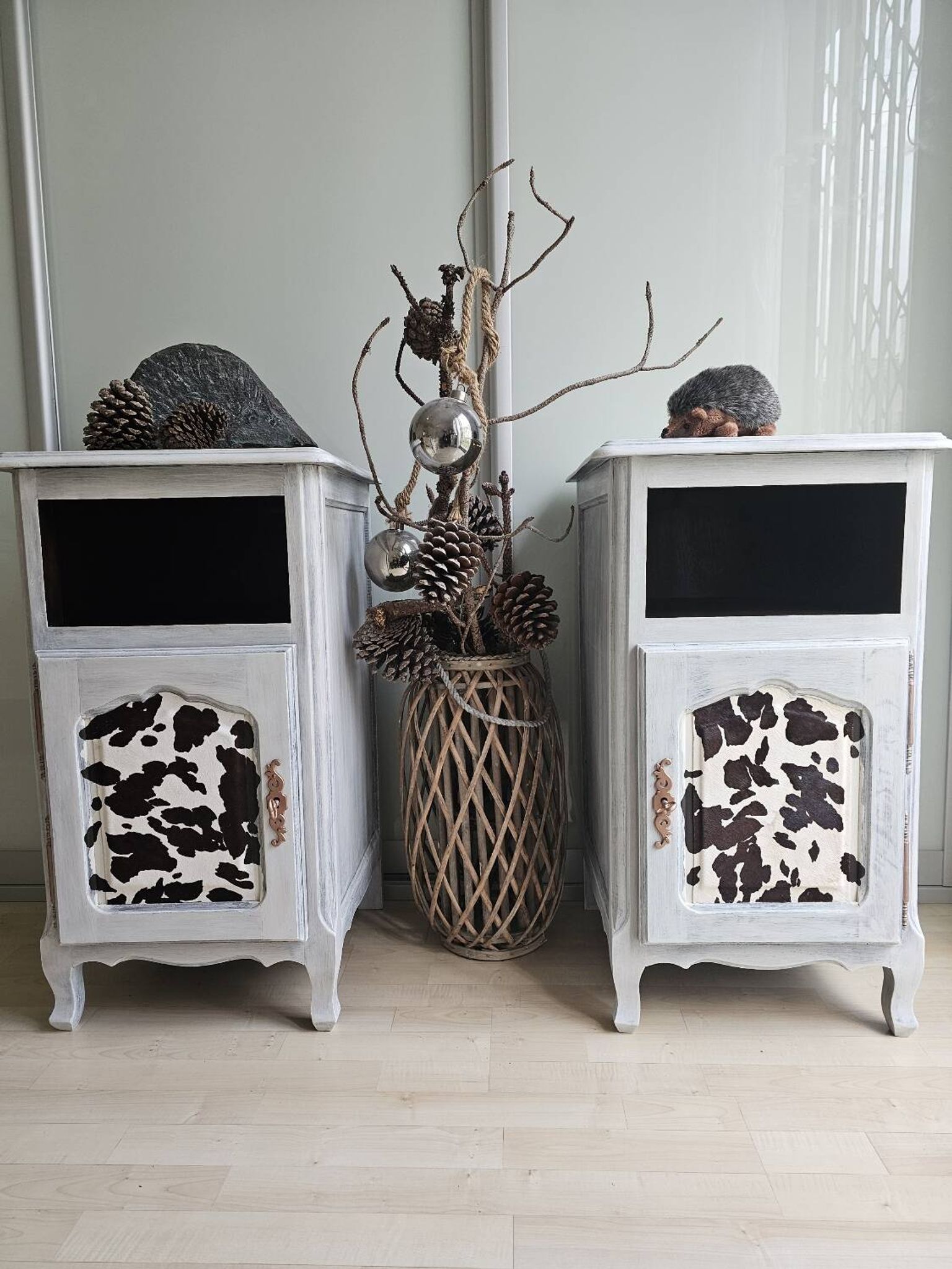 Two solid wood bedside tables with calfskin decoration.