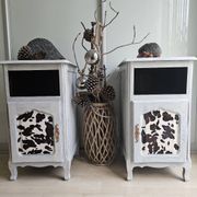 Two solid wood bedside tables with calfskin decoration.