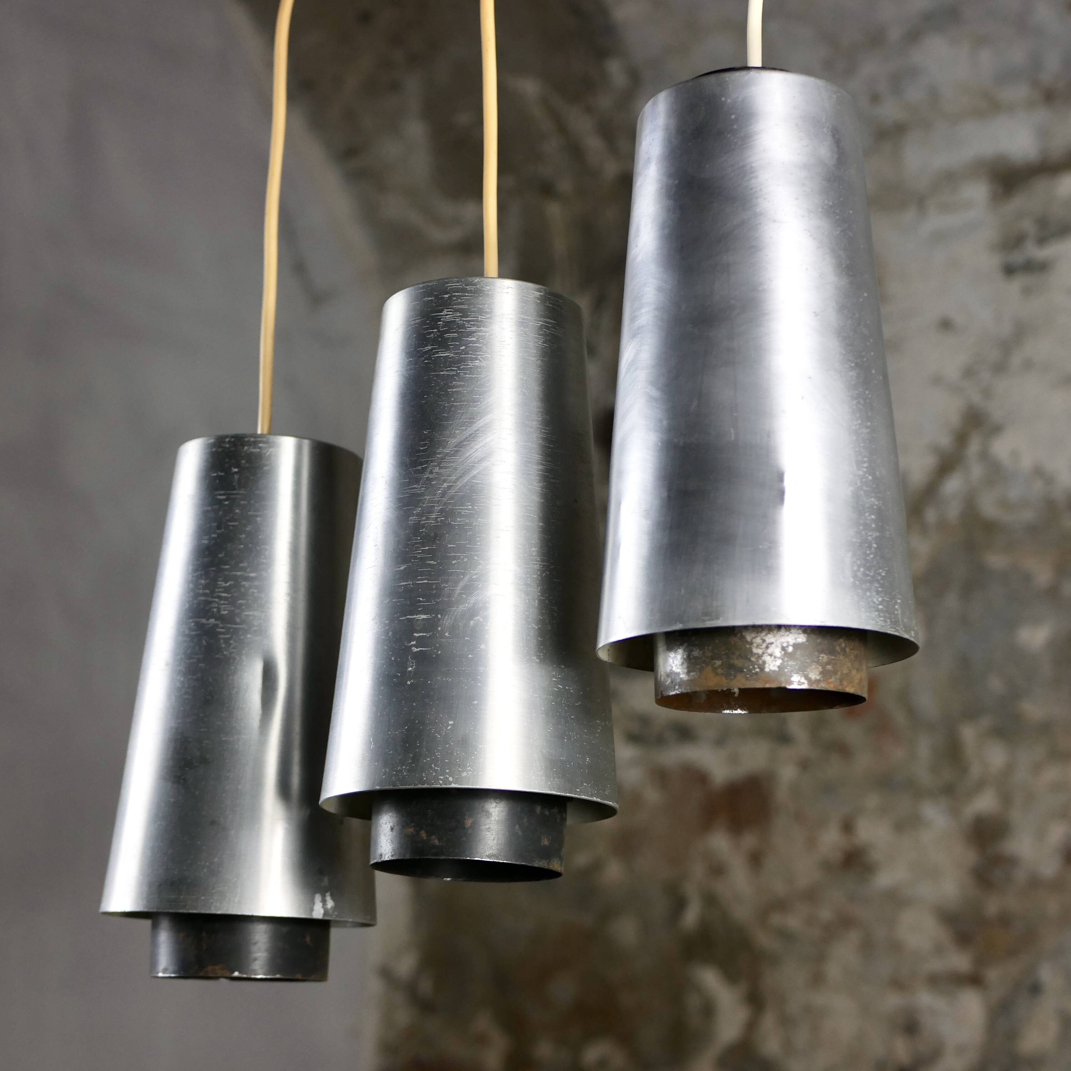 Trio of Raak steel pendant lights, 1960s