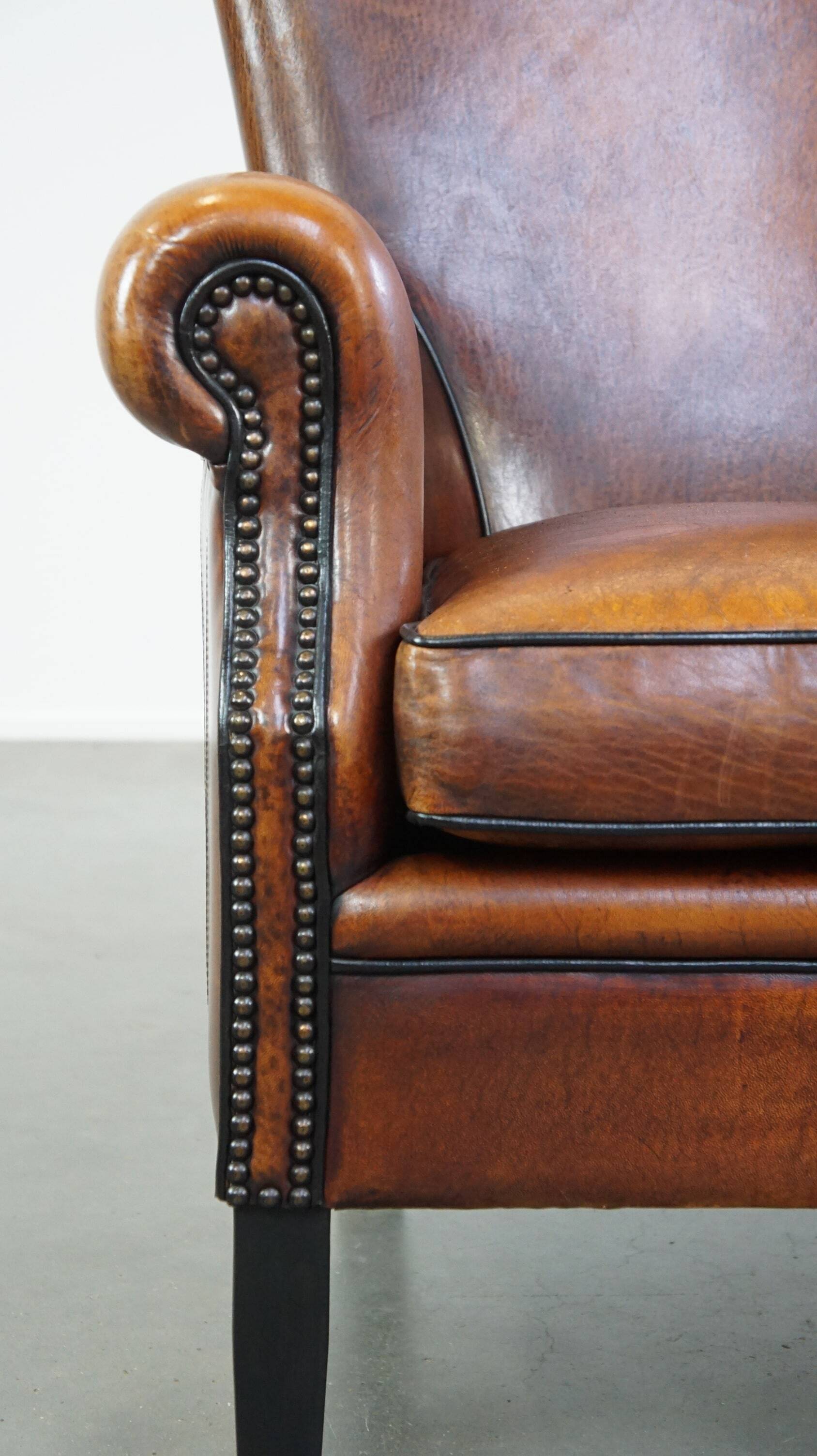 Sheepskin armchair/lounge chair finished with decorative nailheads