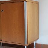 1970s low furniture in wood and metal with sliding doors.