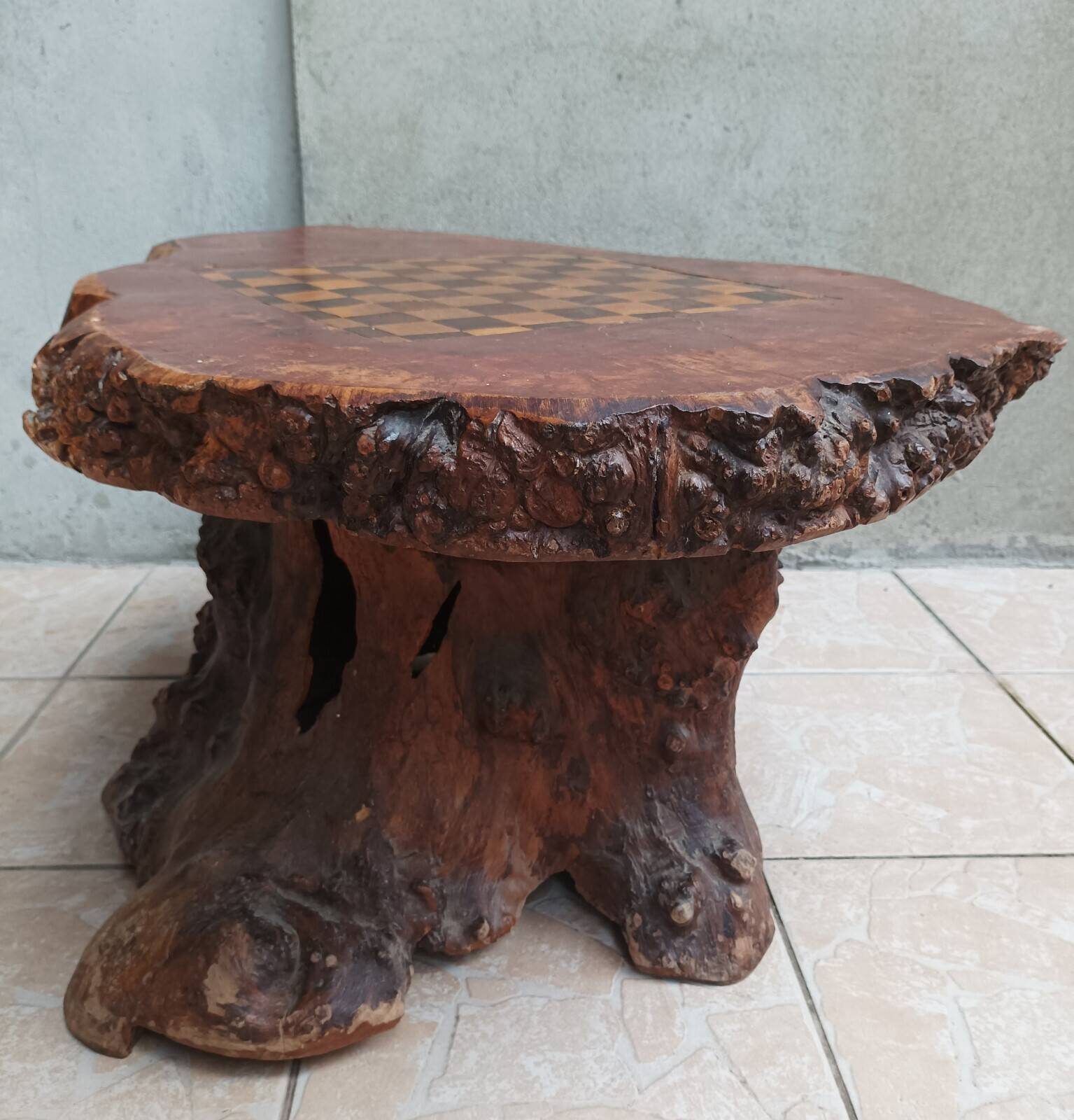Brutalist chessboard coffee table made from tree stump.