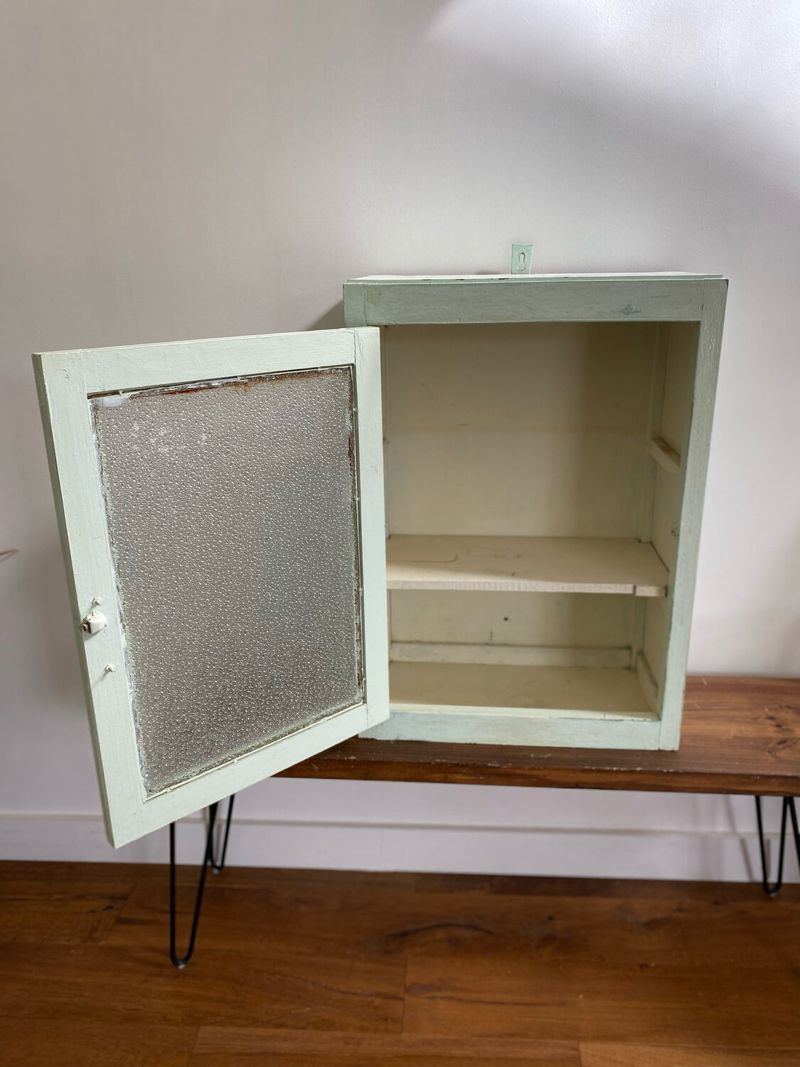 Old medicine cabinet in mint green patinated wood