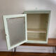 Old medicine cabinet in mint green patinated wood