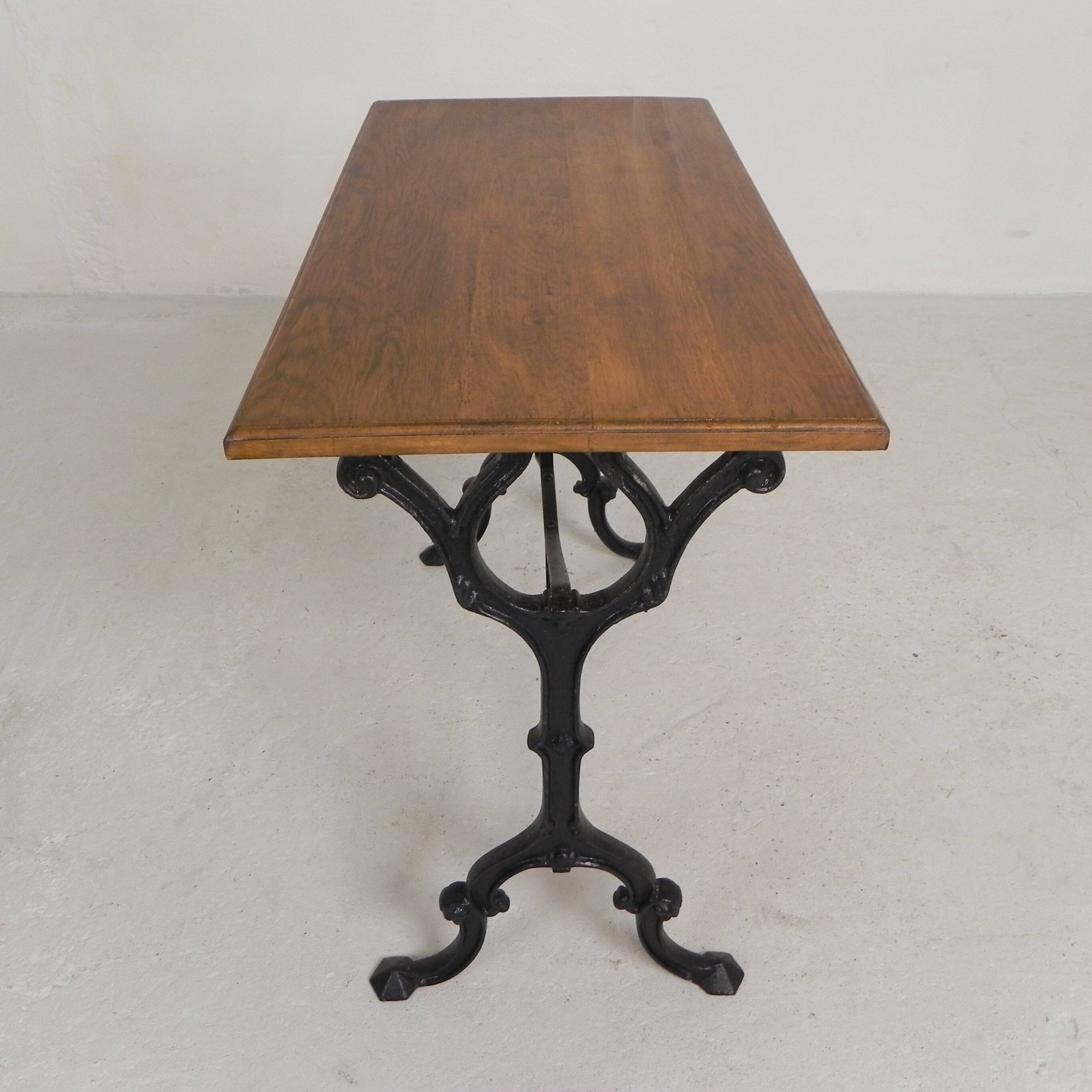 Bistro table with an oak top on a cast iron base, 1930s.