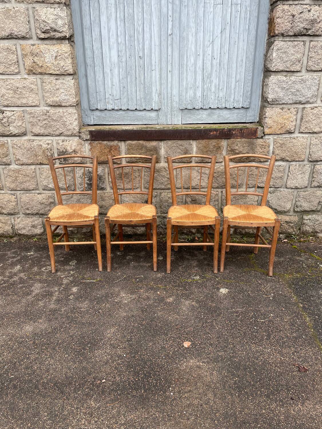 four vintage bistro-style straw chairs