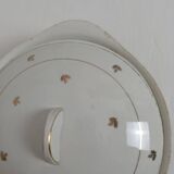 White earthenware soup tureen with a golden pattern.