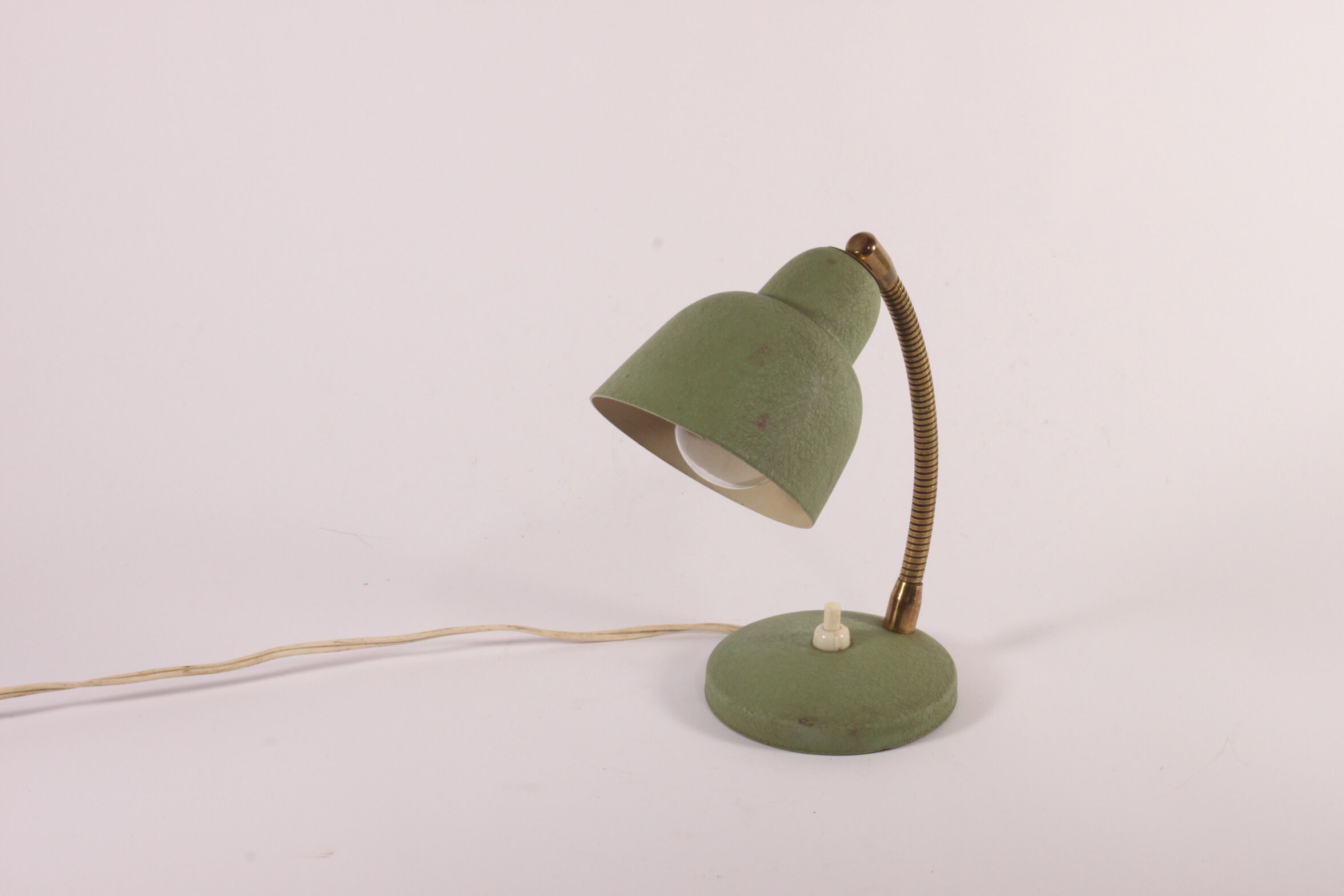Flexible brass and green metal bedside lamp, 1950s.