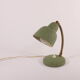 Flexible brass and green metal bedside lamp, 1950s.